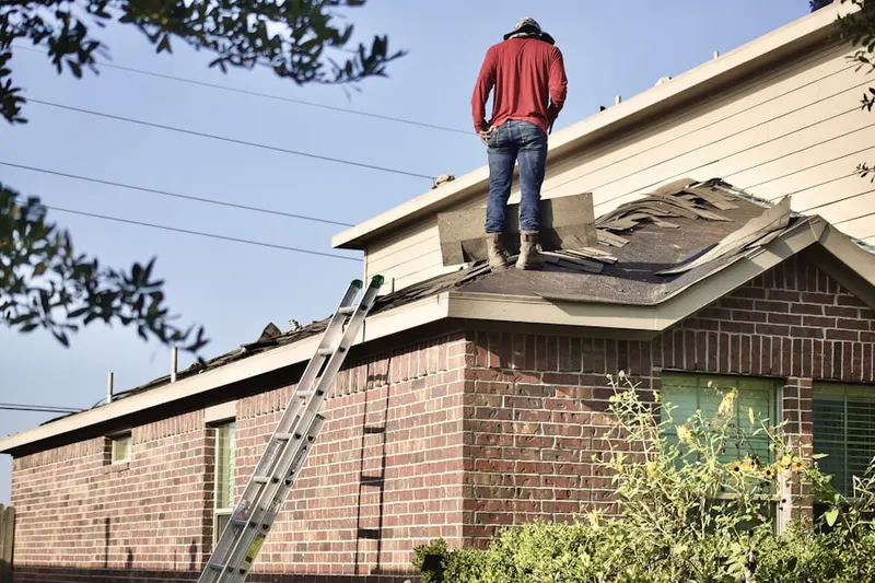 Professional roofer working on a residential roof in Offutt AFB